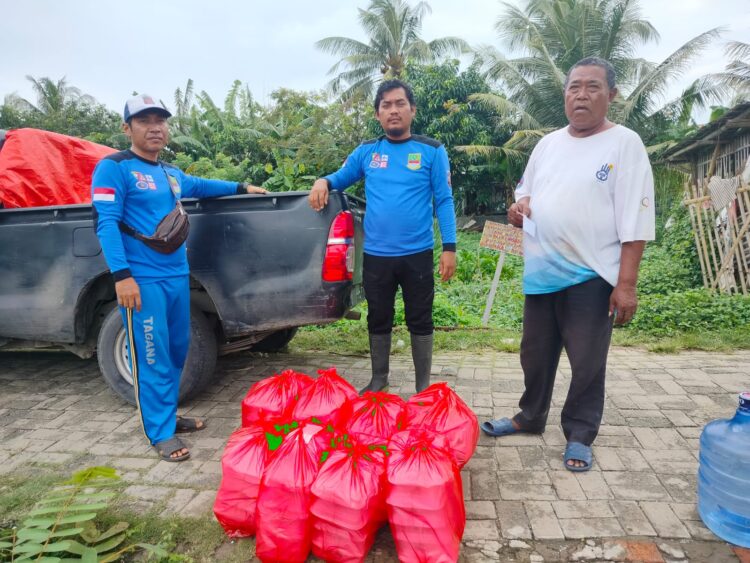BANTUAN : Dinas Sosial (Dinsos) Kabupaten Bekasi bersama Pemerintah Kecamatan Muaragembong menyalurkan bantuan ratusan nasi kotak bagi warga terdampak banjir rob di Kecamatan Muaragembong pada rabu (28/12).